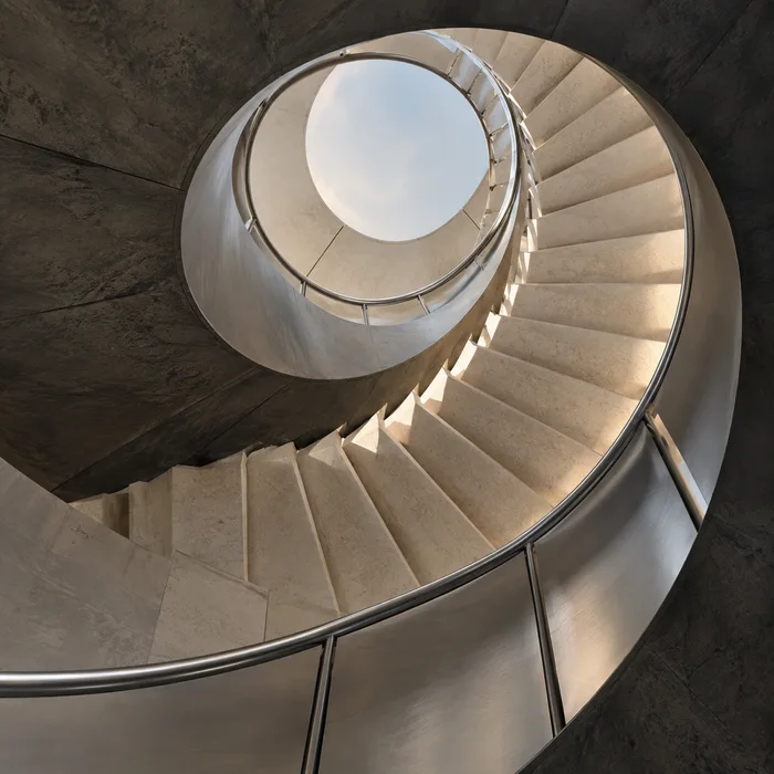 A curving staircase photographed from below